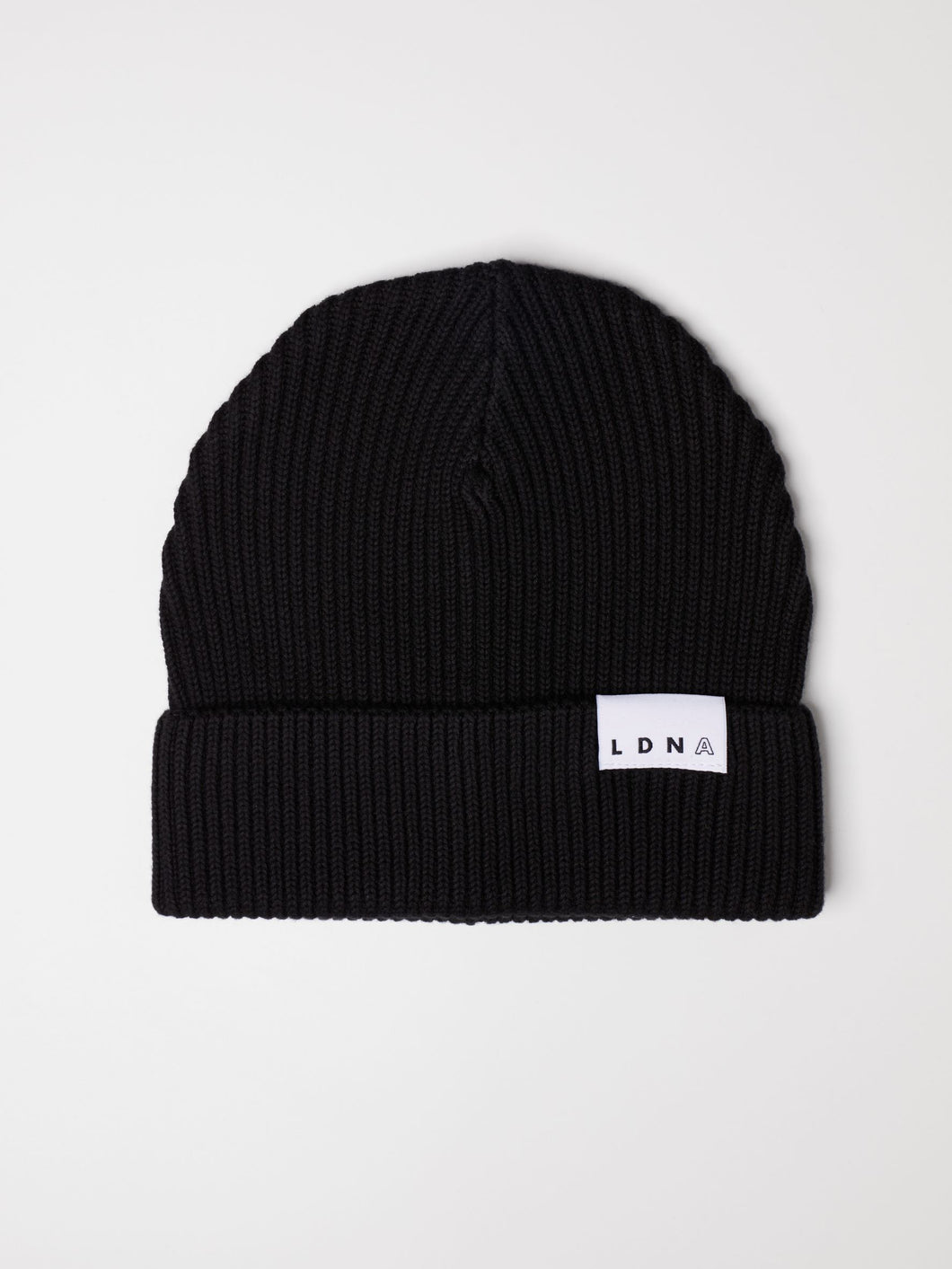 LDNA London black fisherman style beanie hat against white background.