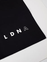 Load image into Gallery viewer, LDNA London black tote bag with close up of LDNA logo
